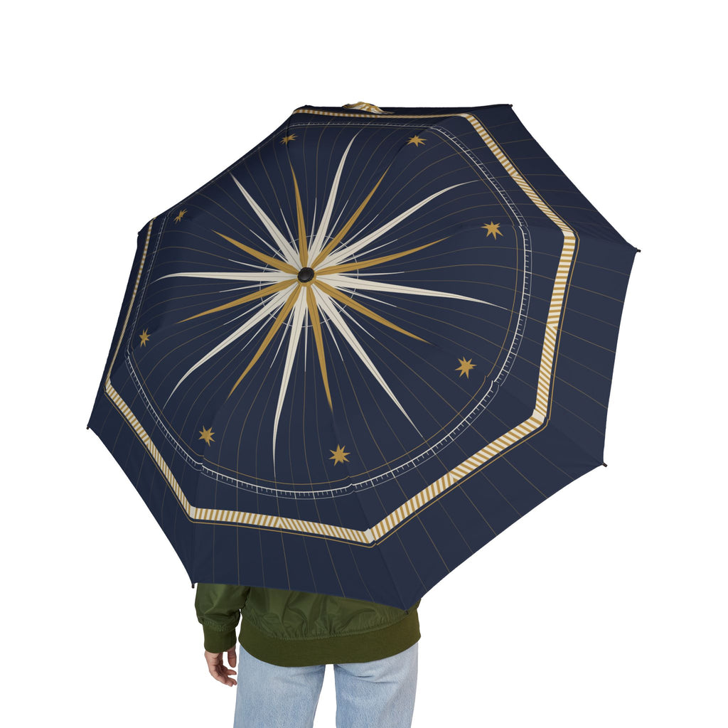Person holding the Grimaldi compass rose folding umbrella, seen from behind