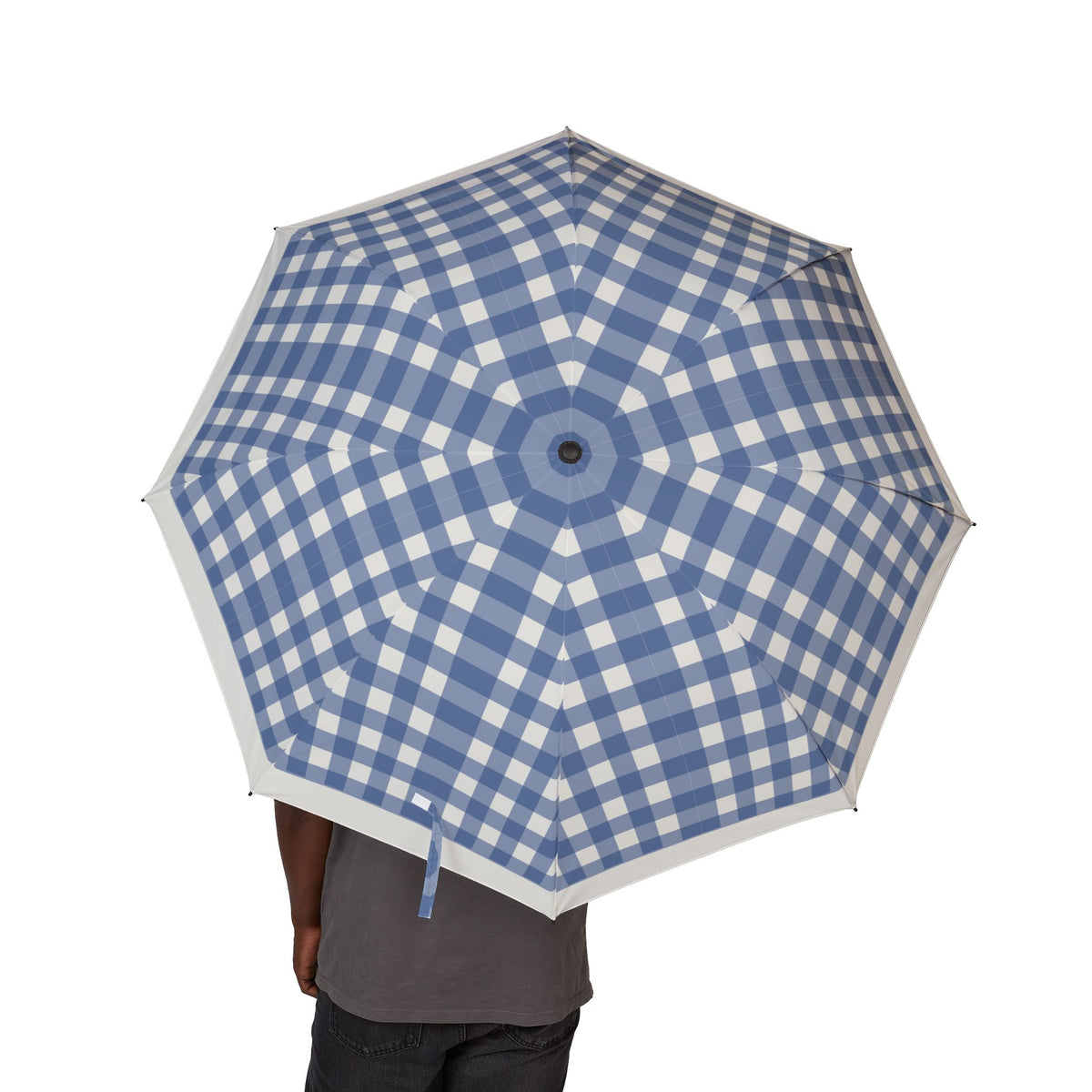 Person holding the Hanover navy gingham folding umbrella, canopy from above
