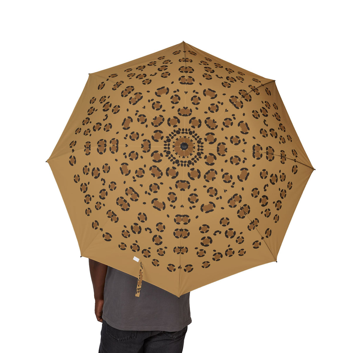 Person holding the Hohenstaufen leopard folding umbrella, canopy from above