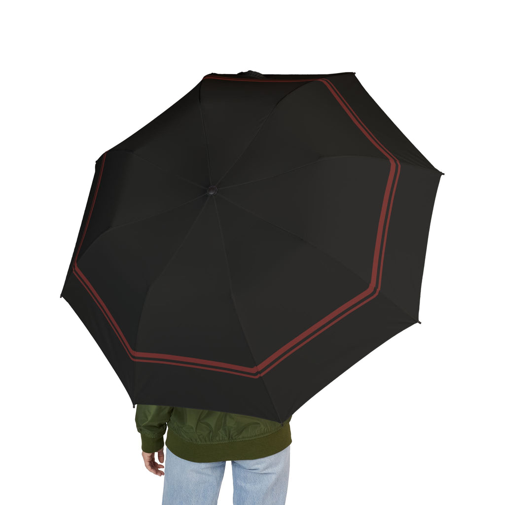 Person holding the Capet black oxblood-border folding umbrella, seen from behind