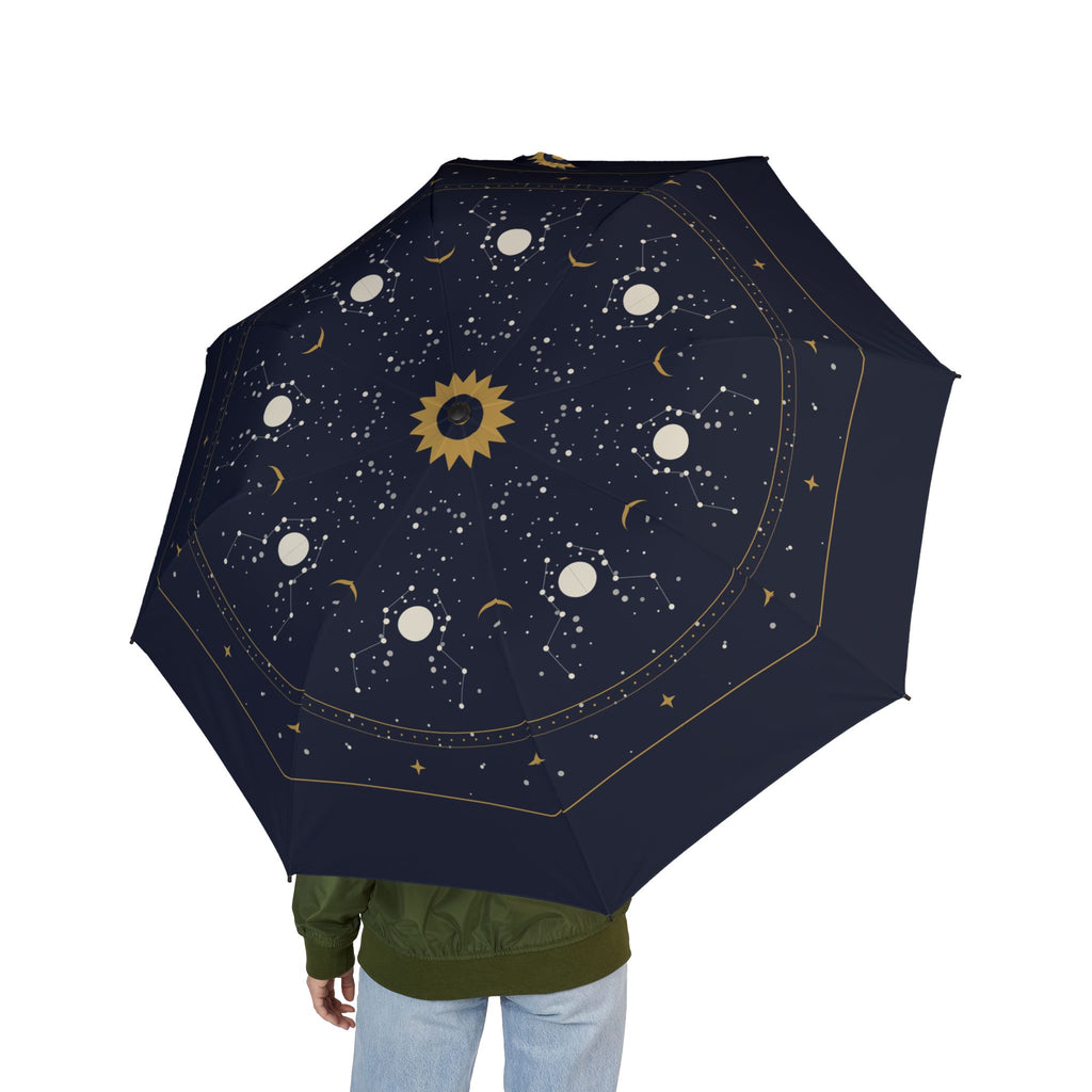 Person holding the Taxis celestial map folding umbrella, seen from behind