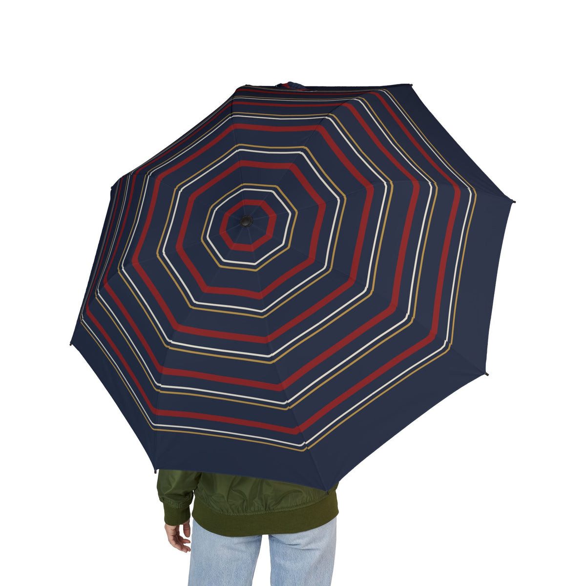 Person holding the Tudor octagon regimental folding umbrella, seen from behind