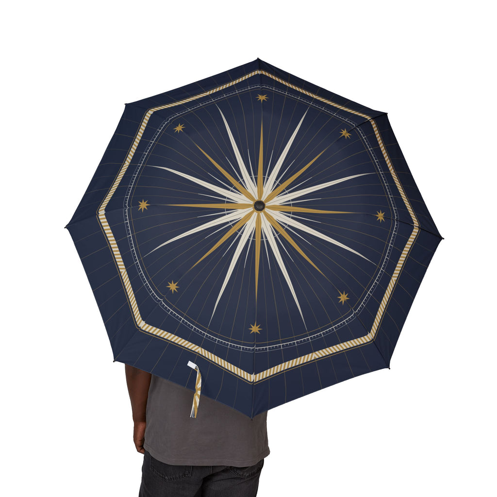 Person holding the Grimaldi compass rose folding umbrella, canopy from above