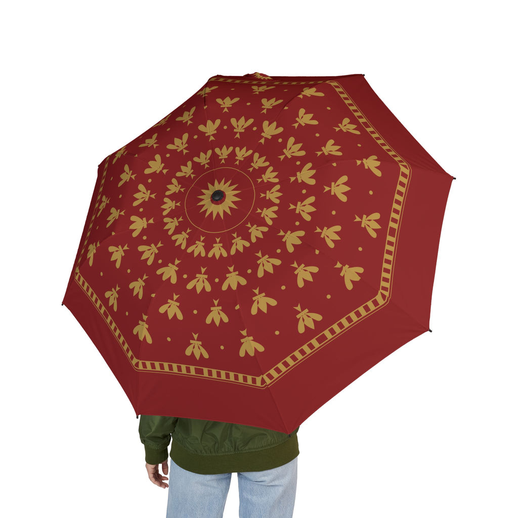 Person holding the Plantagenet fleur-de-lis folding umbrella, seen from behind