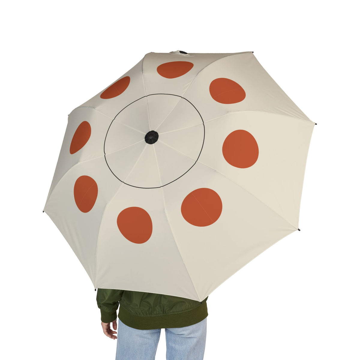 Person holding the Lennox Bauhaus dot folding umbrella, seen from behind