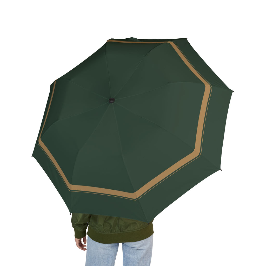 Person holding the Sforza green camel-border folding umbrella, seen from behind