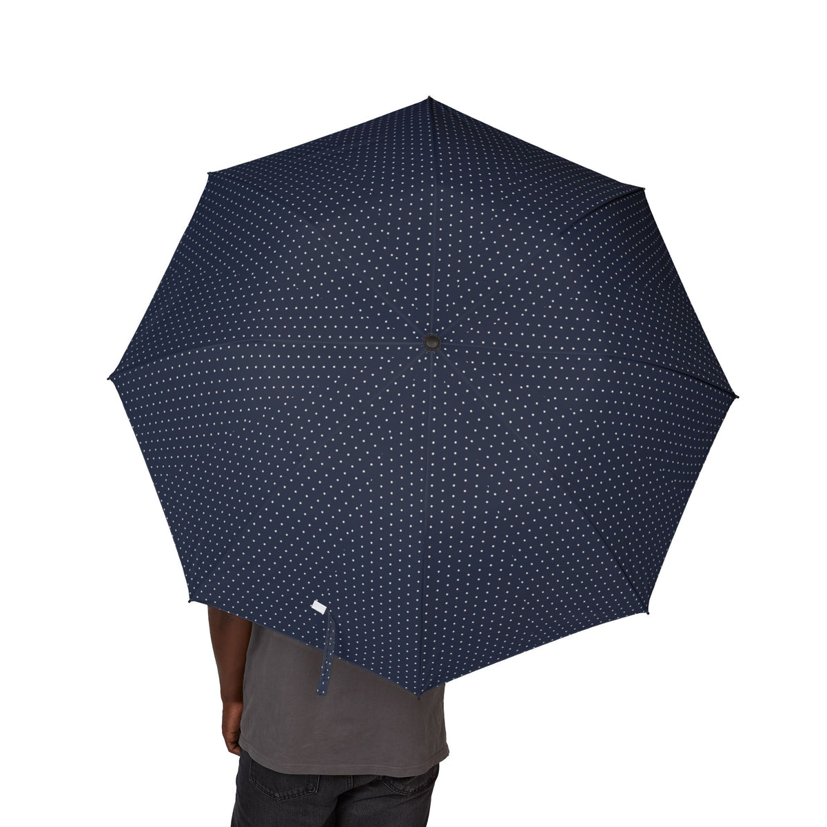 Person holding the Lusignan navy pin dot folding umbrella, canopy from above
