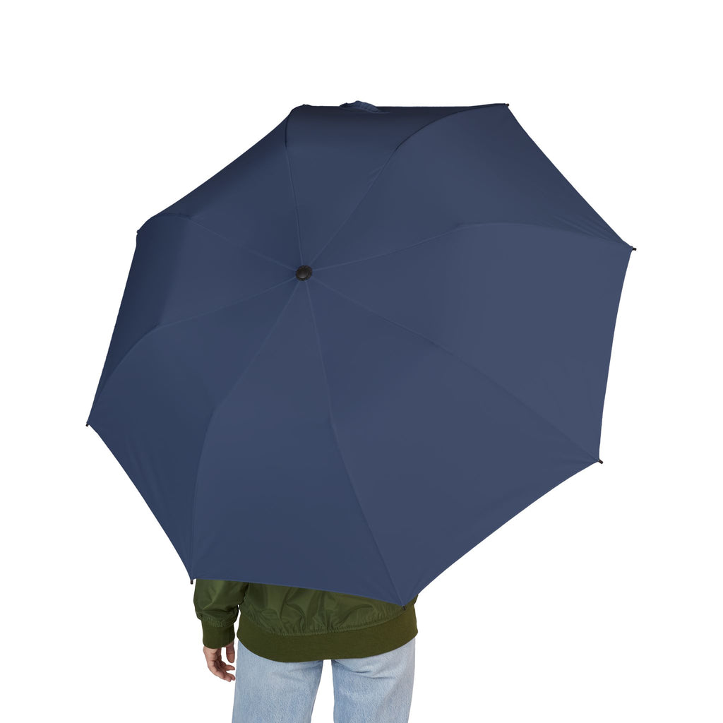 Person holding The Courtenay slate blue folding umbrella, seen from behind