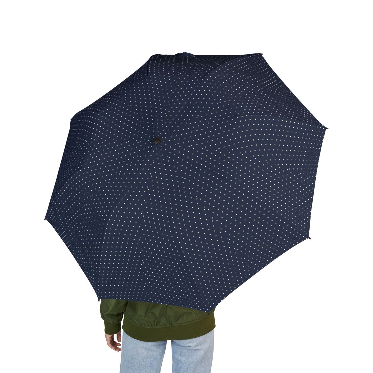 Person holding the Lusignan navy pin dot folding umbrella, seen from behind