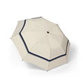 The Mowbray ivory navy-border folding umbrella, open, seen from above
