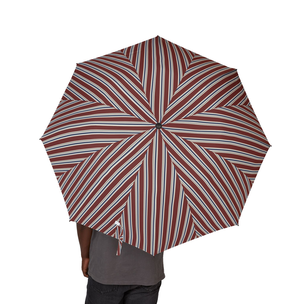 Person holding the Harcourt regimental stripe folding umbrella, seen from behind, canopy from above