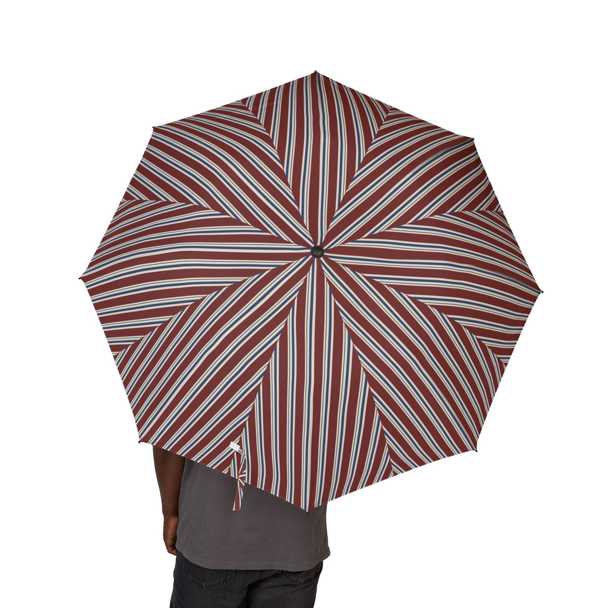 Person holding the Harcourt regimental stripe folding umbrella, seen from behind, canopy from above