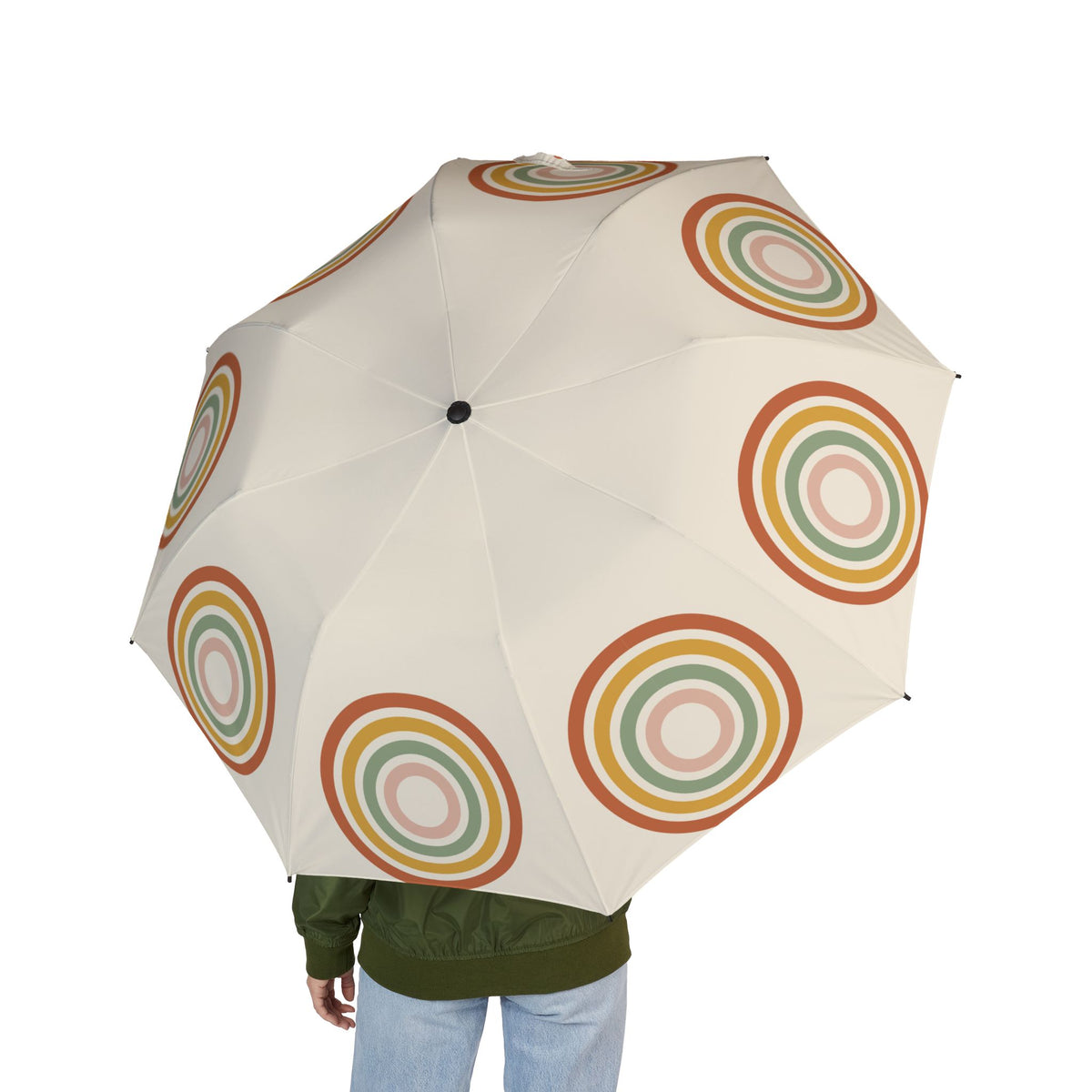Person holding the Fiennes boho arch folding umbrella, seen from behind
