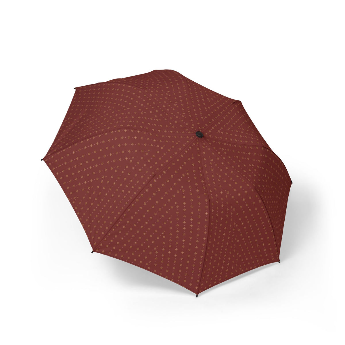 The Vendôme oxblood foulard folding umbrella, open, seen from above — gold medallions across eight panels