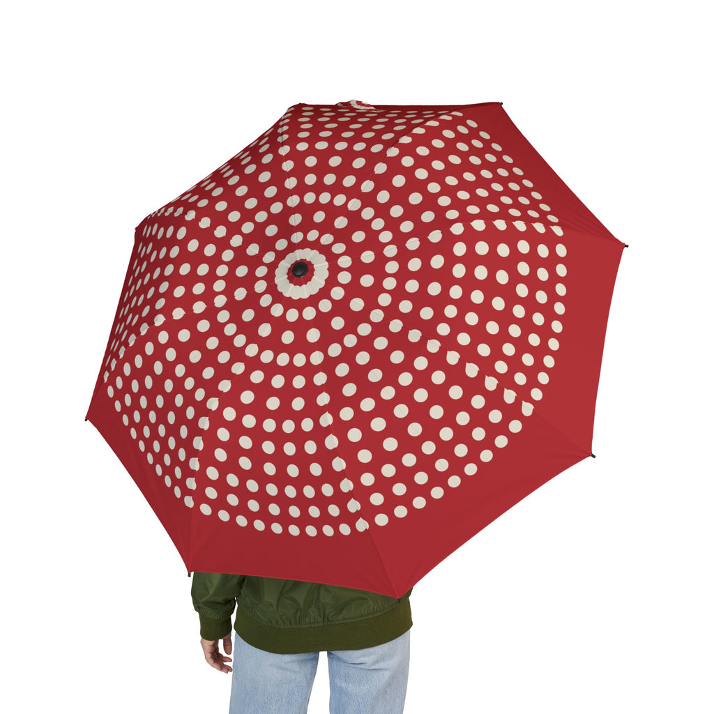 Person holding the Seymour red polka dot folding umbrella, seen from behind
