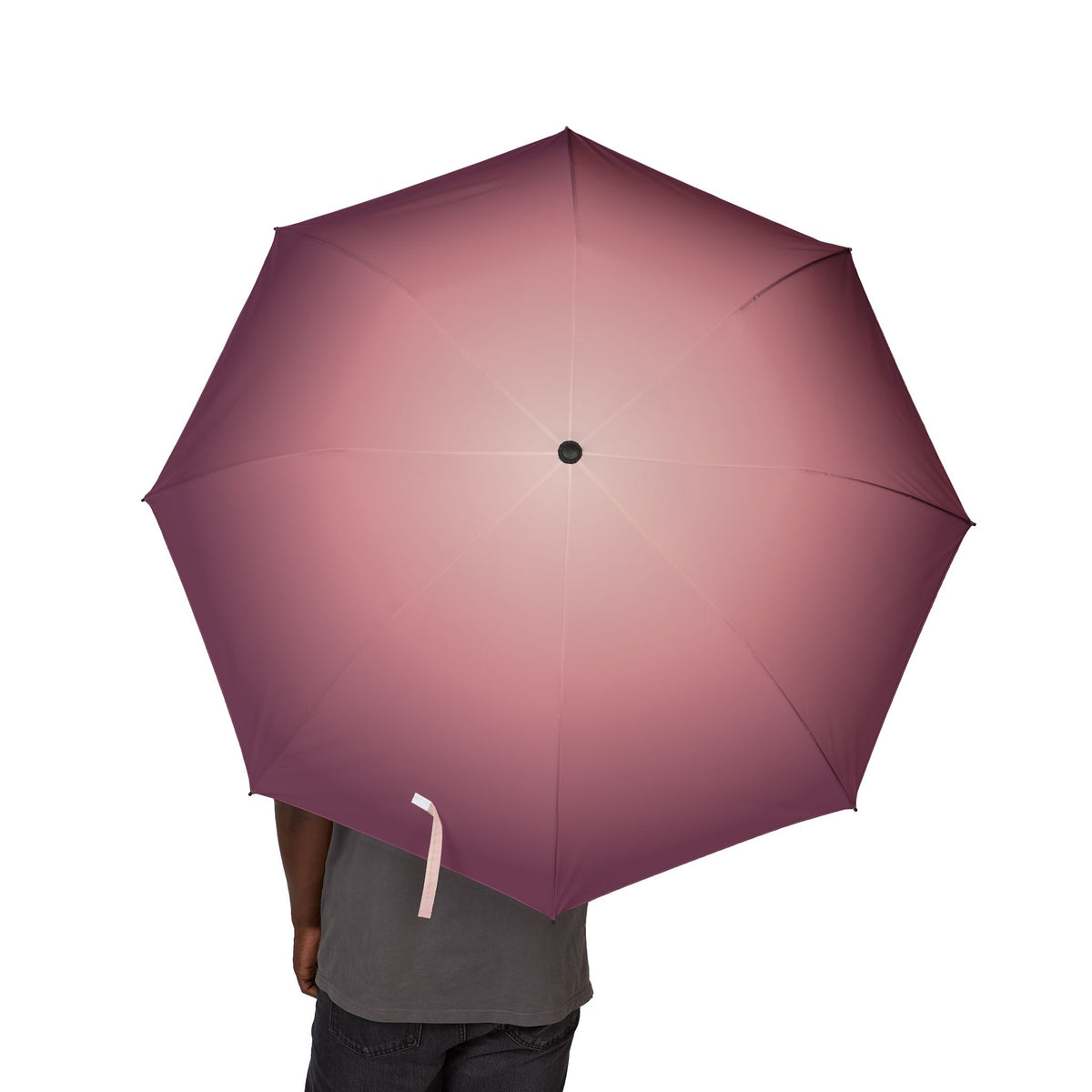 Person holding the Rothschild blush ombré folding umbrella, canopy from above