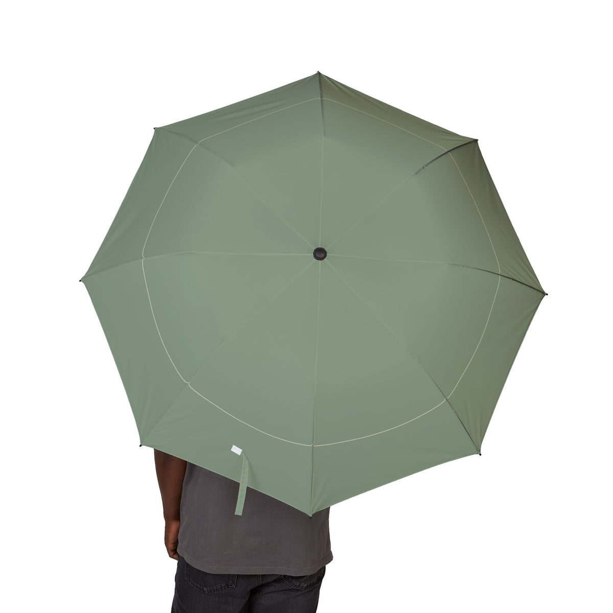 Person holding the Mortimer sage hairline folding umbrella, canopy from above