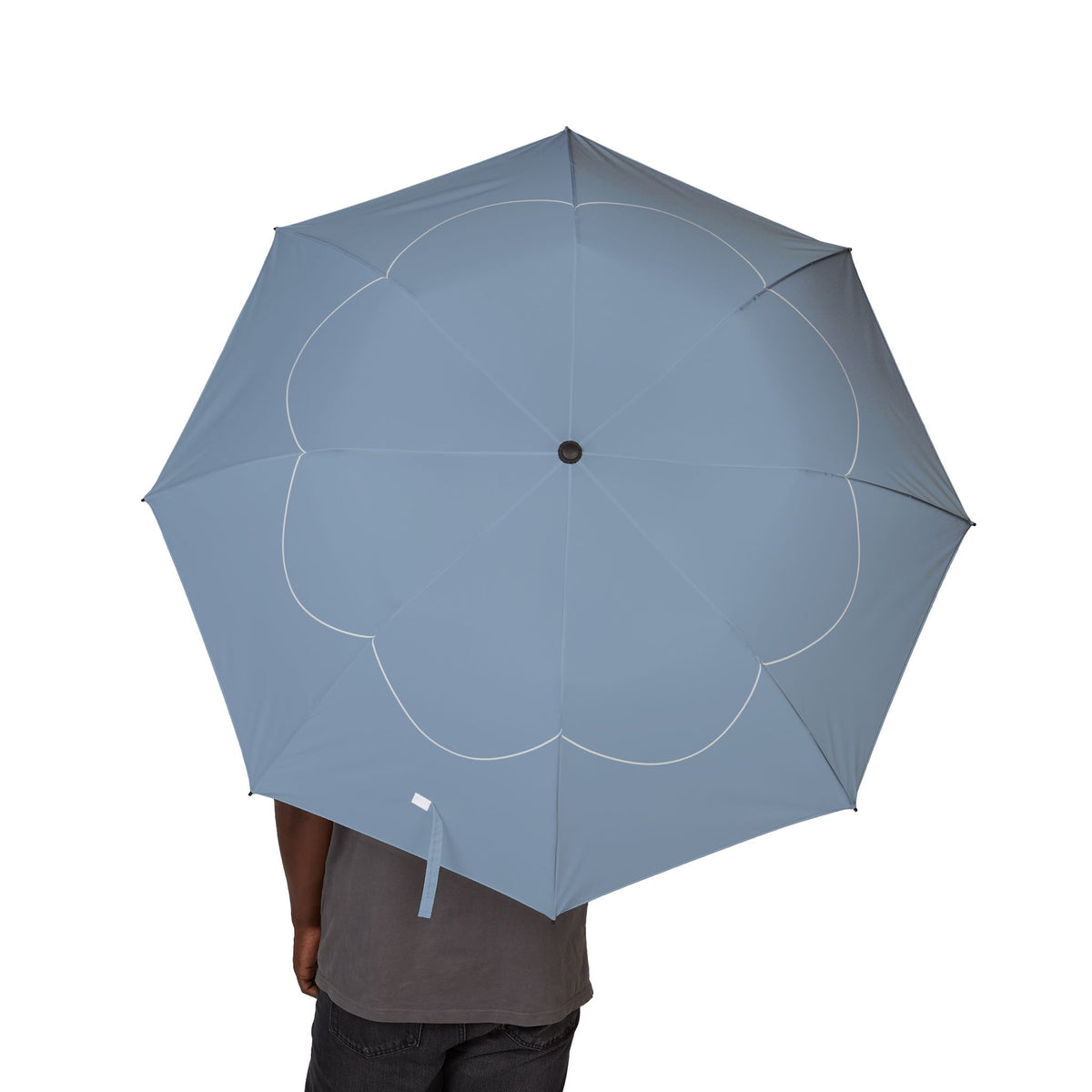Person holding the Berkeley scallop line folding umbrella, canopy from above