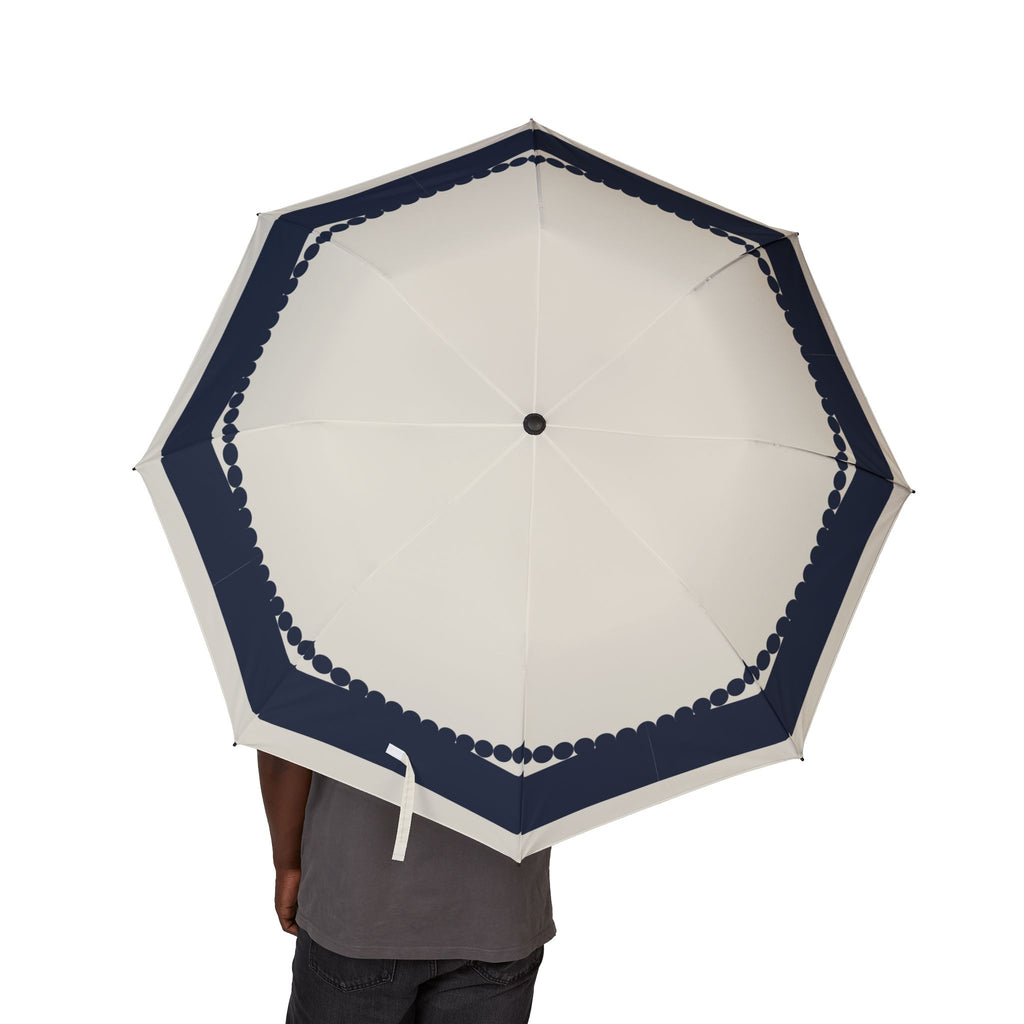 Person holding the Wyndham navy scallop folding umbrella, canopy from above