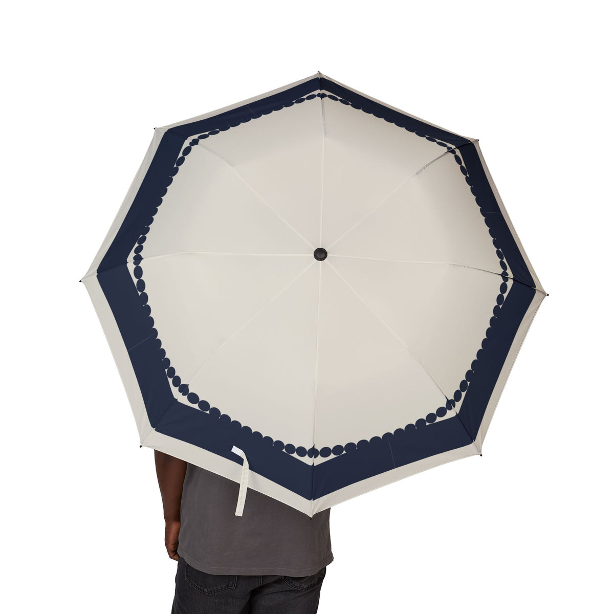 Person holding the Wyndham navy scallop folding umbrella, canopy from above