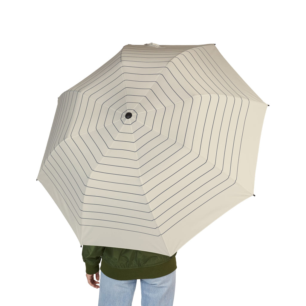 Person holding the Schwarzenberg octagon pinstripe folding umbrella, seen from behind