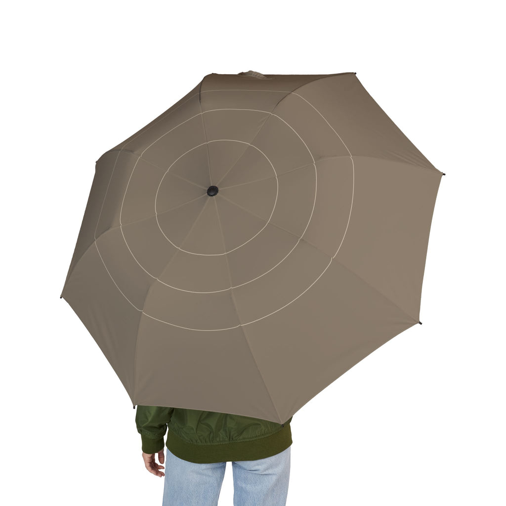 Person holding the Carew taupe ring folding umbrella, seen from behind