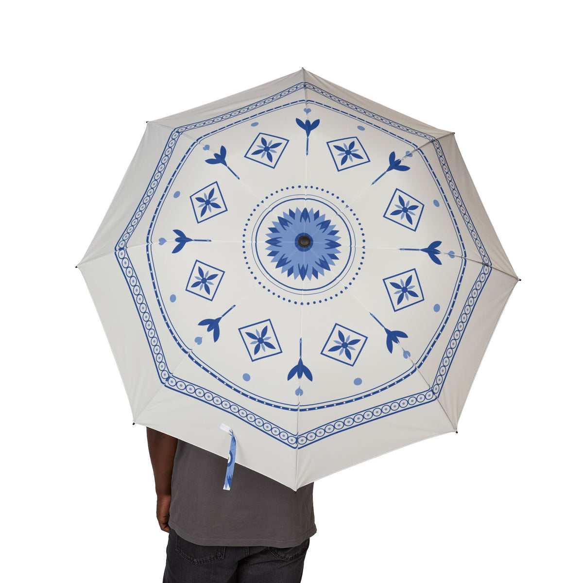 Person holding the Orange-Nassau Delft blue folding umbrella, canopy from above