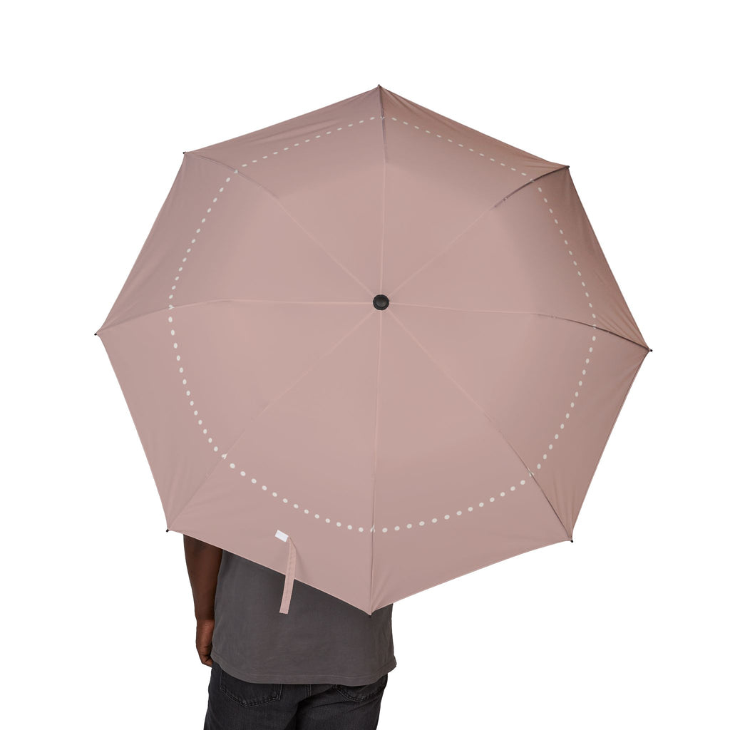 Person holding the Ashley blush pearl folding umbrella, canopy from above