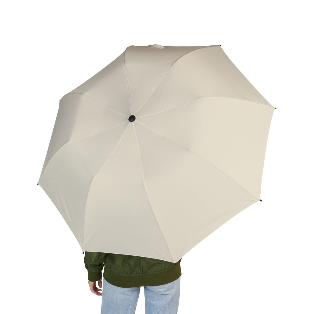 Person holding The Colonna ivory folding umbrella, seen from behind