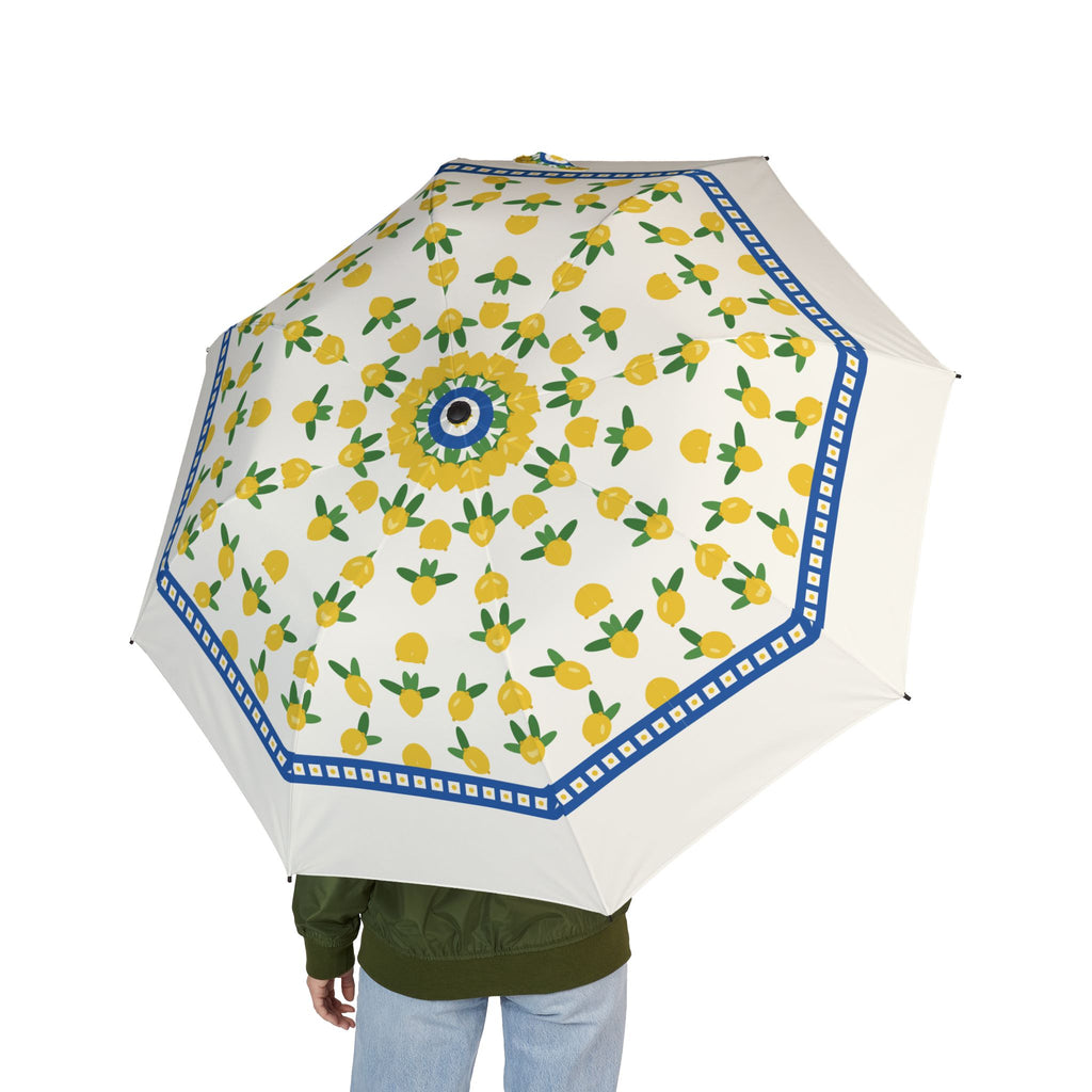 Person holding the Caracciolo Amalfi lemon folding umbrella, seen from behind