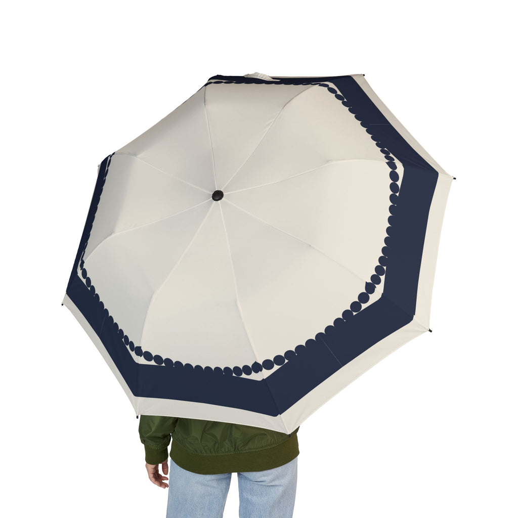 Person holding the Wyndham navy scallop folding umbrella, seen from behind