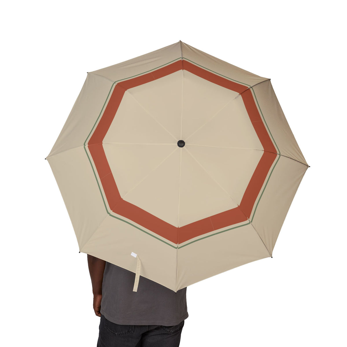 Person holding the Lascelles sand and terracotta folding umbrella, canopy from above