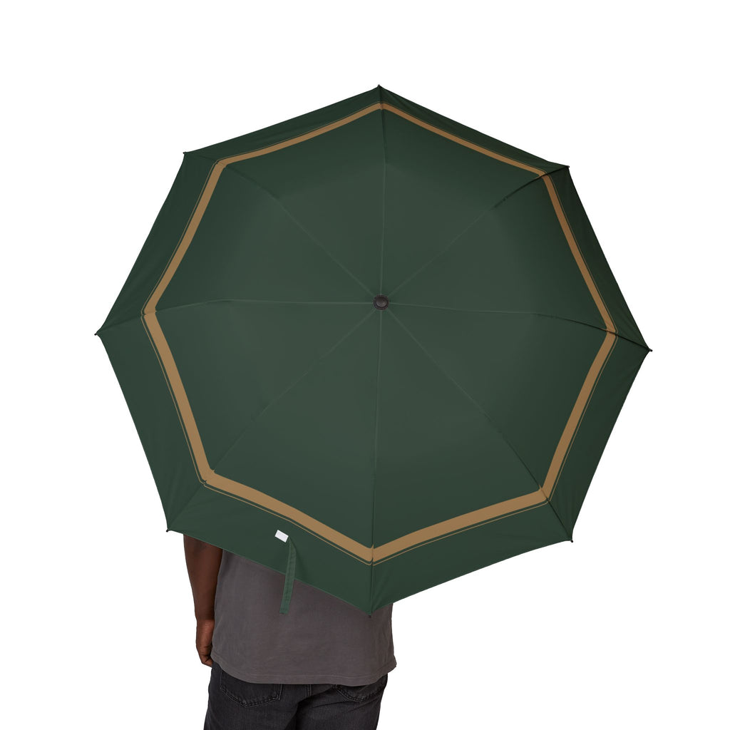 Person holding the Sforza green camel-border folding umbrella, canopy from above