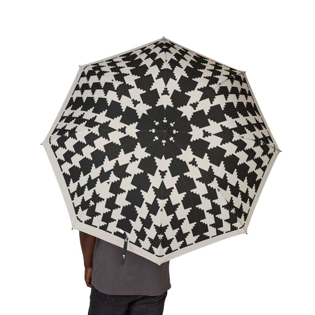 Person holding the Bernadotte houndstooth folding umbrella, canopy from above