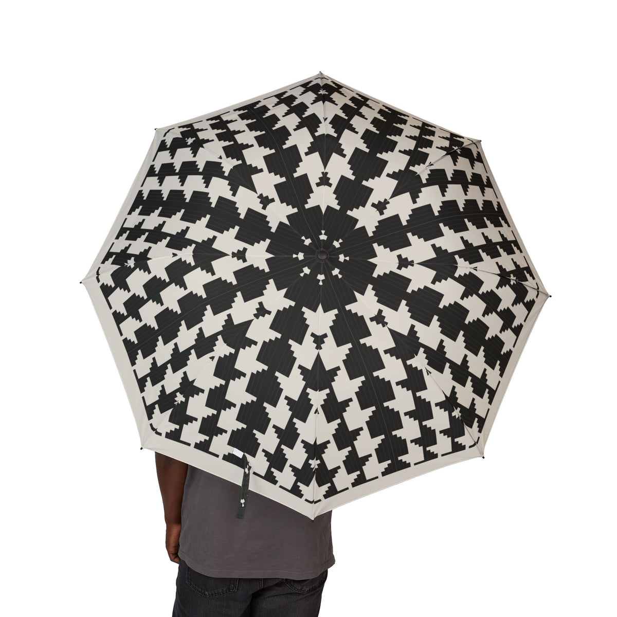 Person holding the Bernadotte houndstooth folding umbrella, canopy from above