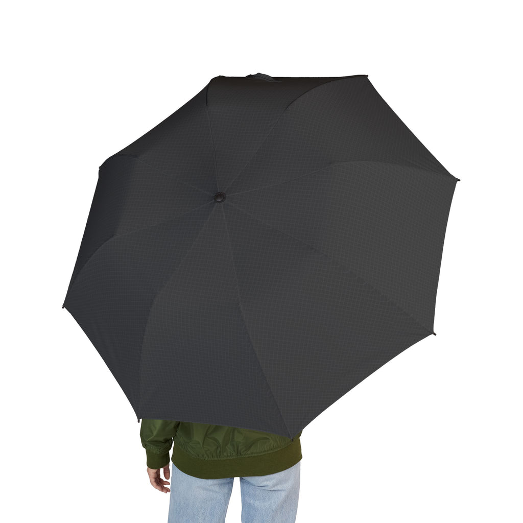 Person holding the Este charcoal tonal micro-check folding umbrella, seen from behind